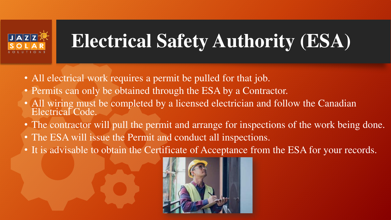 An electrician in a hard hat and safety glasses working on an electrical panel.